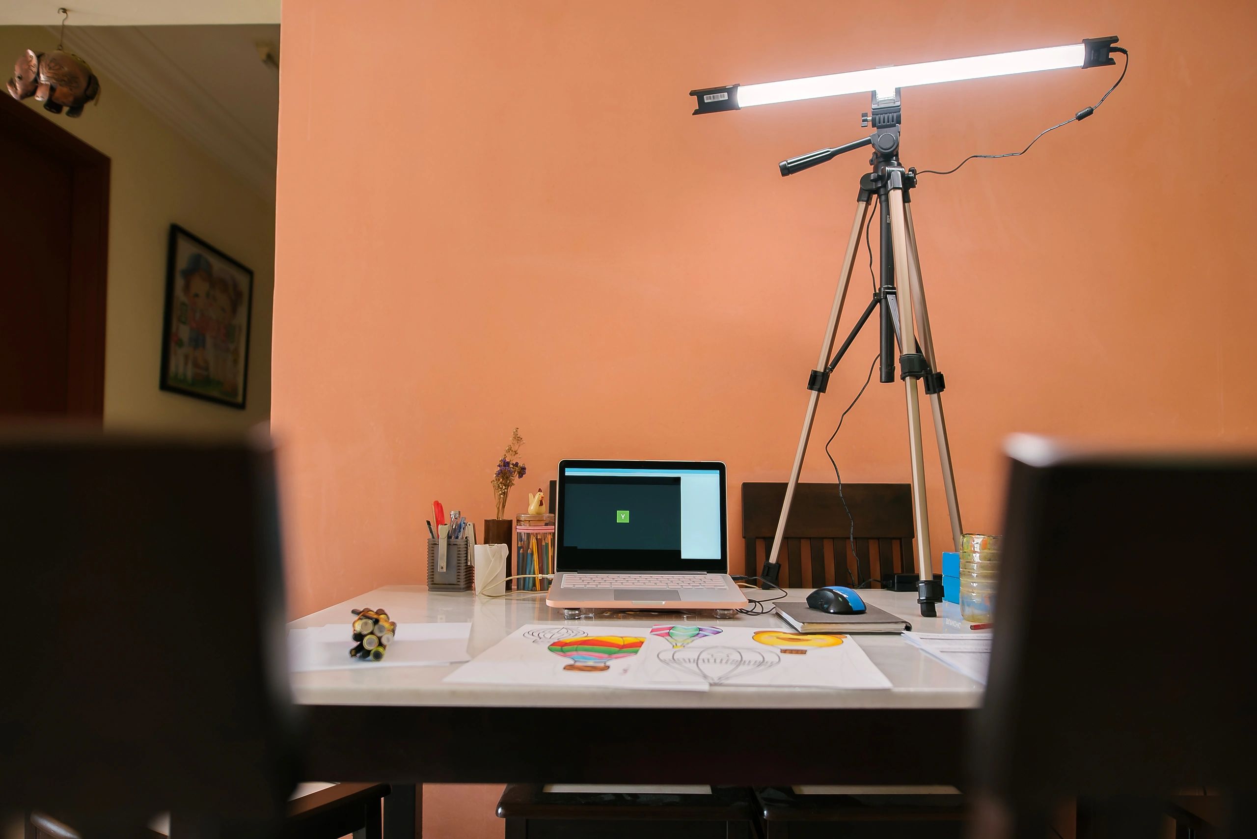 Home art workspace with drawing tools and laptop